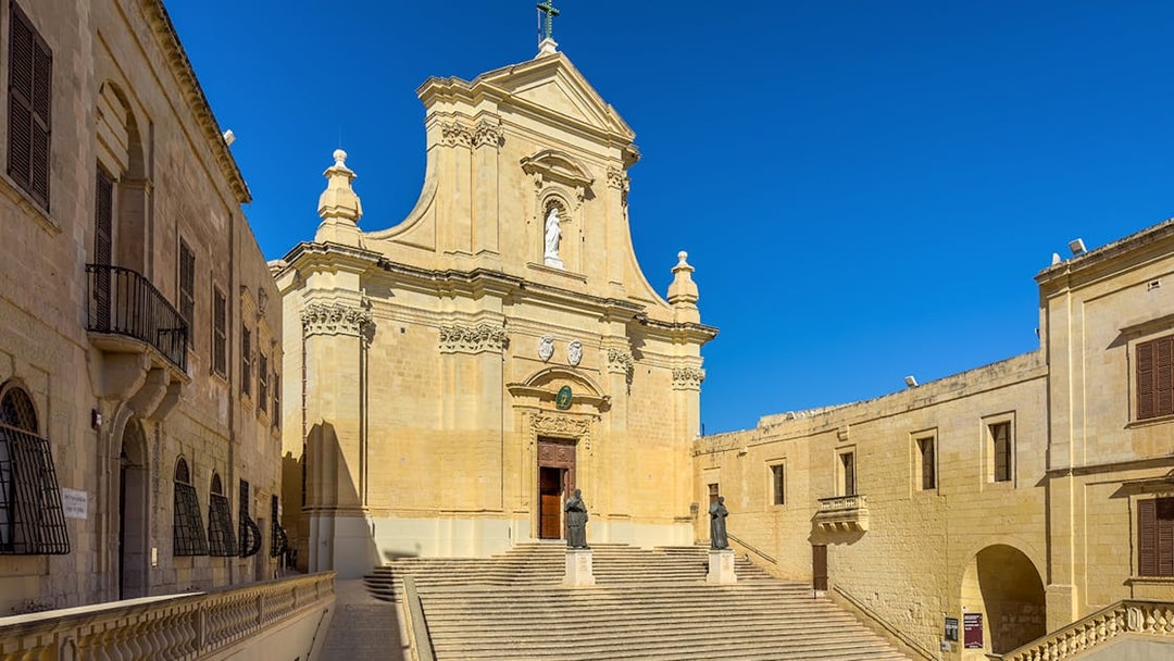 Rabat Cathedral facade with statues and steps on Gozo island, Malta.