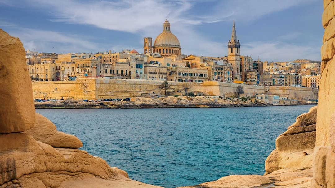 Valletta skyline with dome and spire viewed from the sea, Malta.
