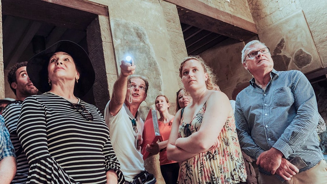 Group of tourists on a Herculaneum private guided tour inside ancient ruins.