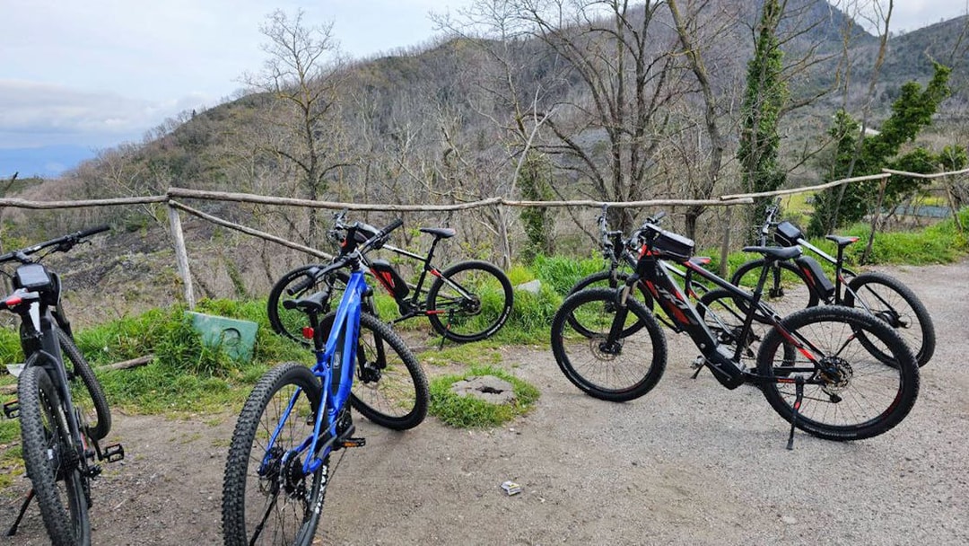 E-bikes parked on a trail with Mount Vesuvius in the background during a guided tour from Sorrento.