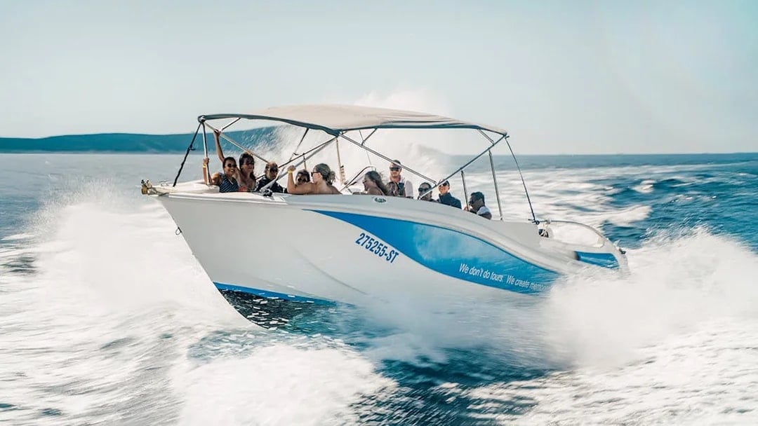 Guests speedboating in Blue Lagoon, enjoying the ride on a sunny day.