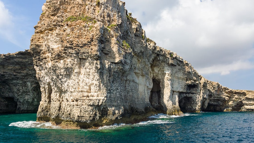 Rocky cliffs and sea caves near Ahrax Point, Mellieha, Comino, Malta.