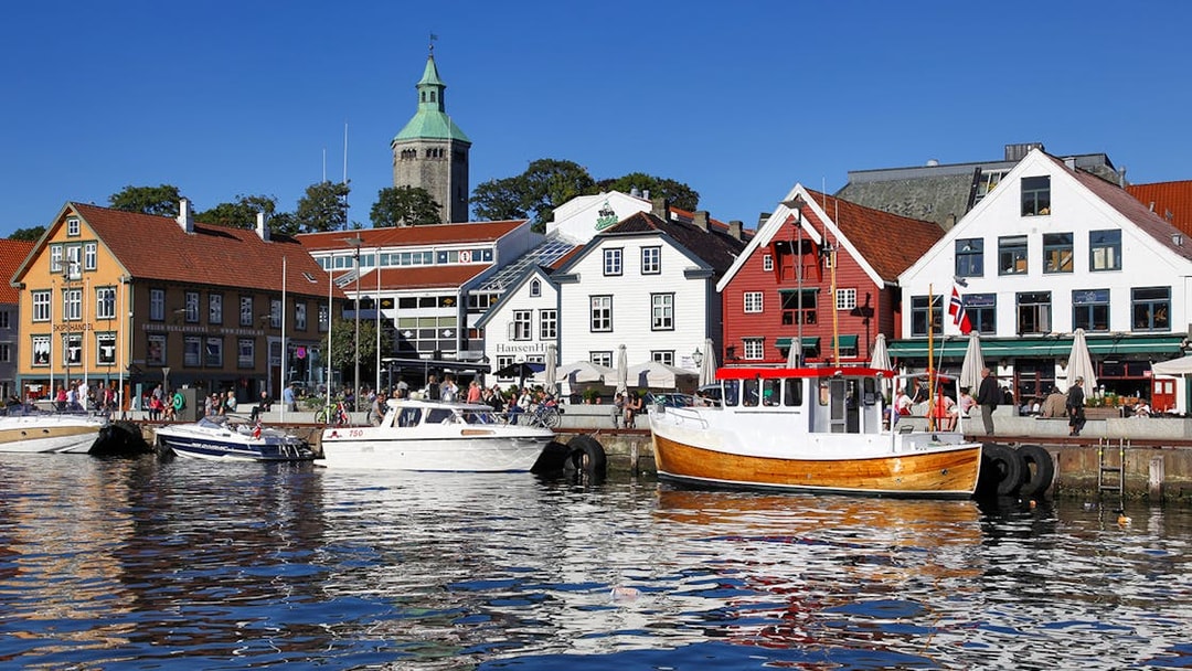 Stavanger harbour with colorful buildings and boats during Fjord Sailing.
