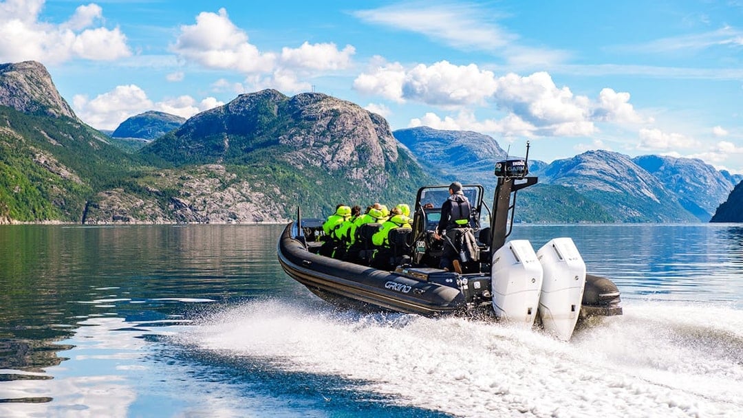 Guests on a RIB boat during Lysefjord Safari, Norway, with scenic mountain views.