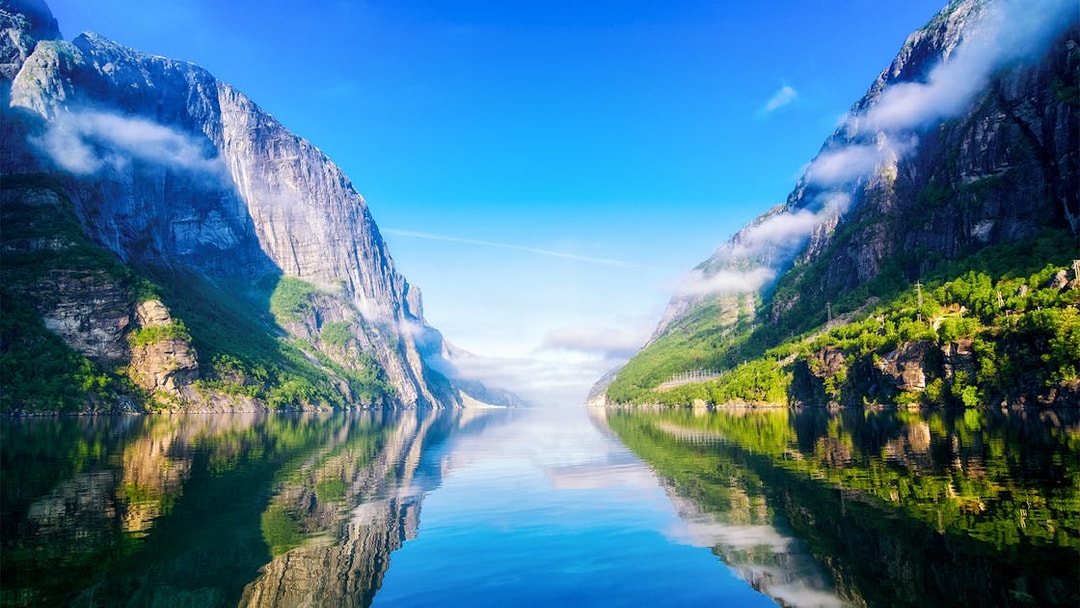 Lysefjord in Norway with steep cliffs and calm reflective waters.