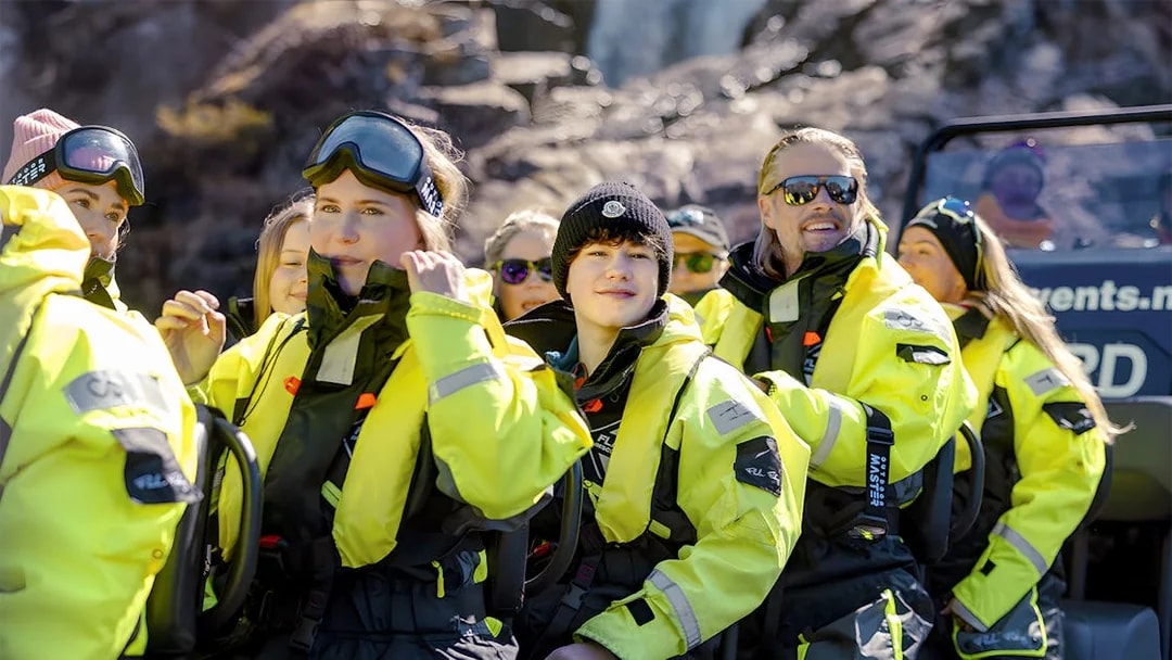 Guests in yellow suits on a RIB boat for Lysefjord Safari with a guide.