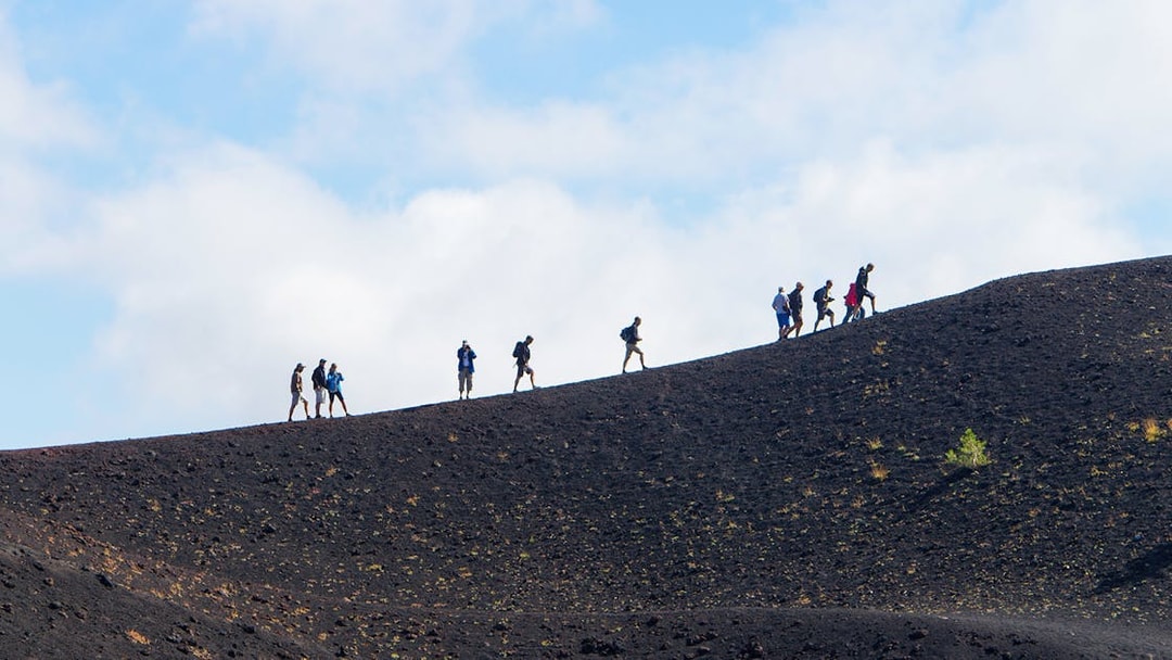 Hikers ascending Mount Etna in Sicily, Italy.