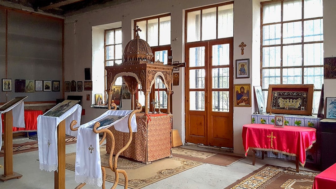 Interior of Berat Castle chapel with religious icons and wooden altar.