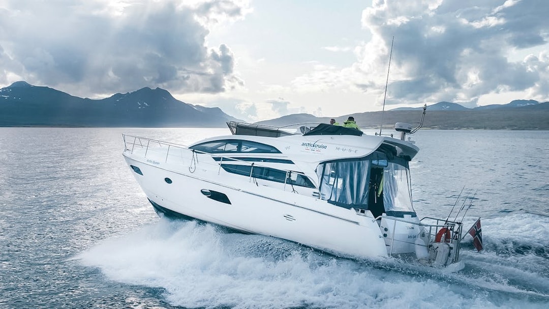 Boat cruising in Tromso fjord during silent whale watching tour.