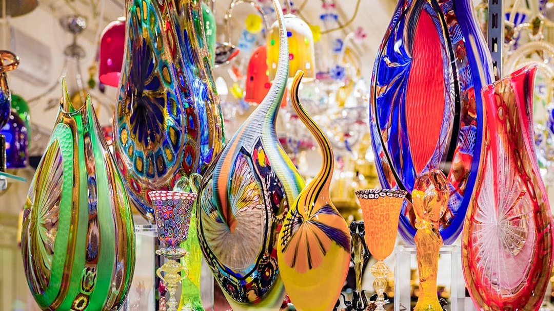 Colorful Murano glass artifacts displayed at a museum exhibit.