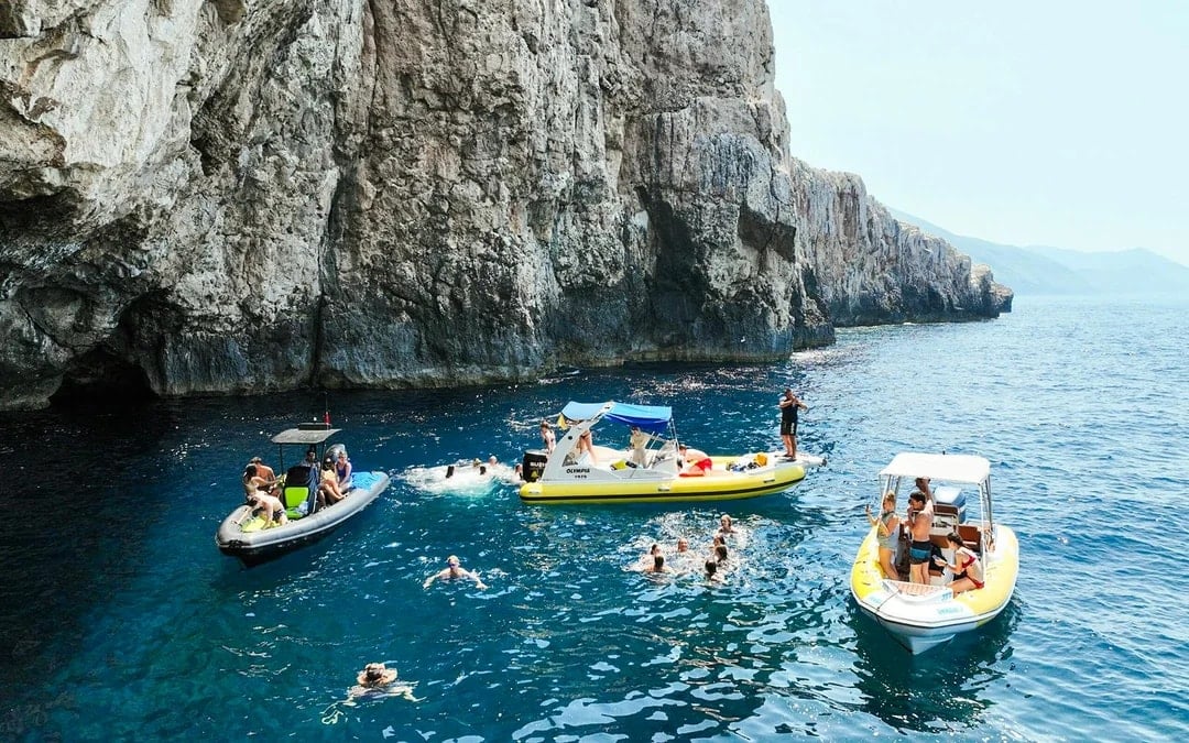 From Vlore: Unknown Escape Party Boat Cruise with Drinks, Music & Secret Swim Stops Image 1