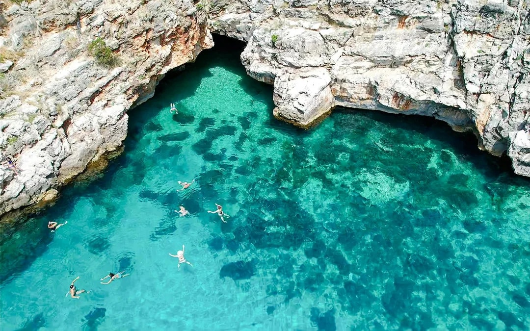 From Vlore: Unknown Escape Party Boat Cruise with Drinks, Music & Secret Swim Stops Image 4