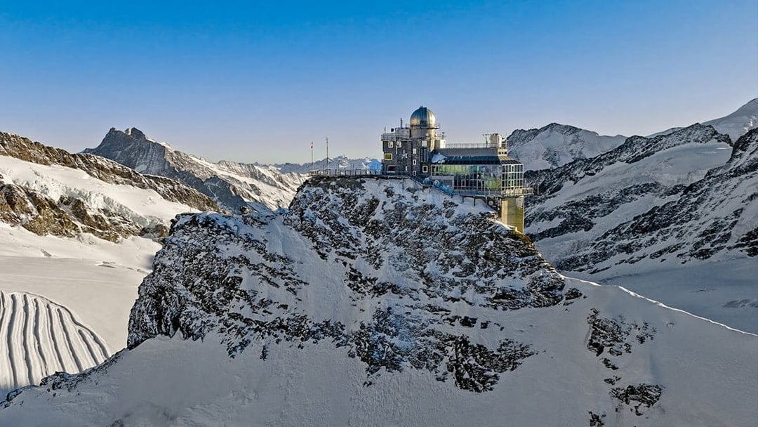 Jungfraujoch observatory on snowy mountain peak, Swiss Alps, during day trip from Zürich.