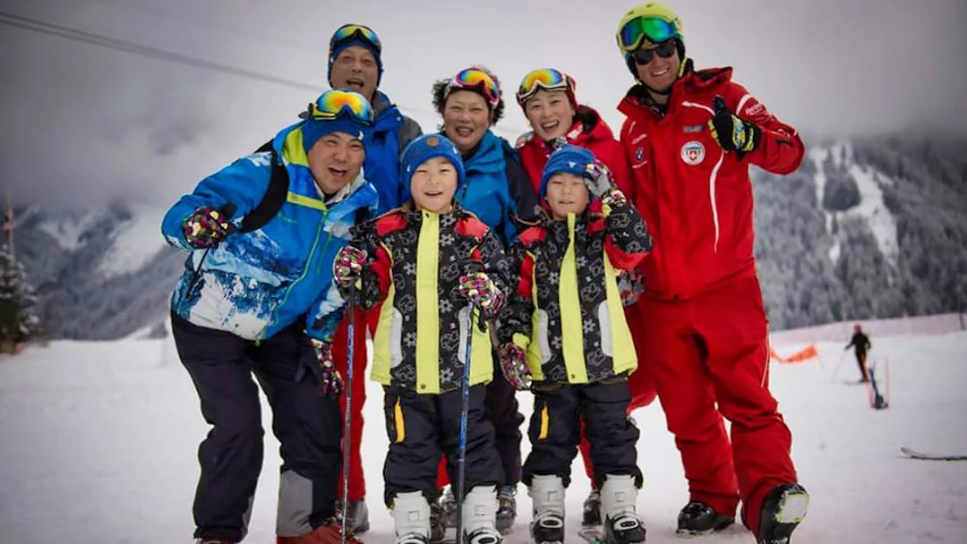 Group of skiers posing on a snowy slope in Jungfrau Region, Switzerland.