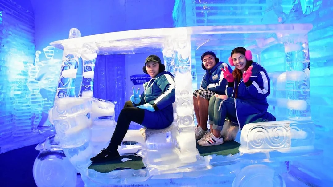 Visitors sitting in an ice tuk-tuk at Frost Magical Ice of Siam, Pattaya.