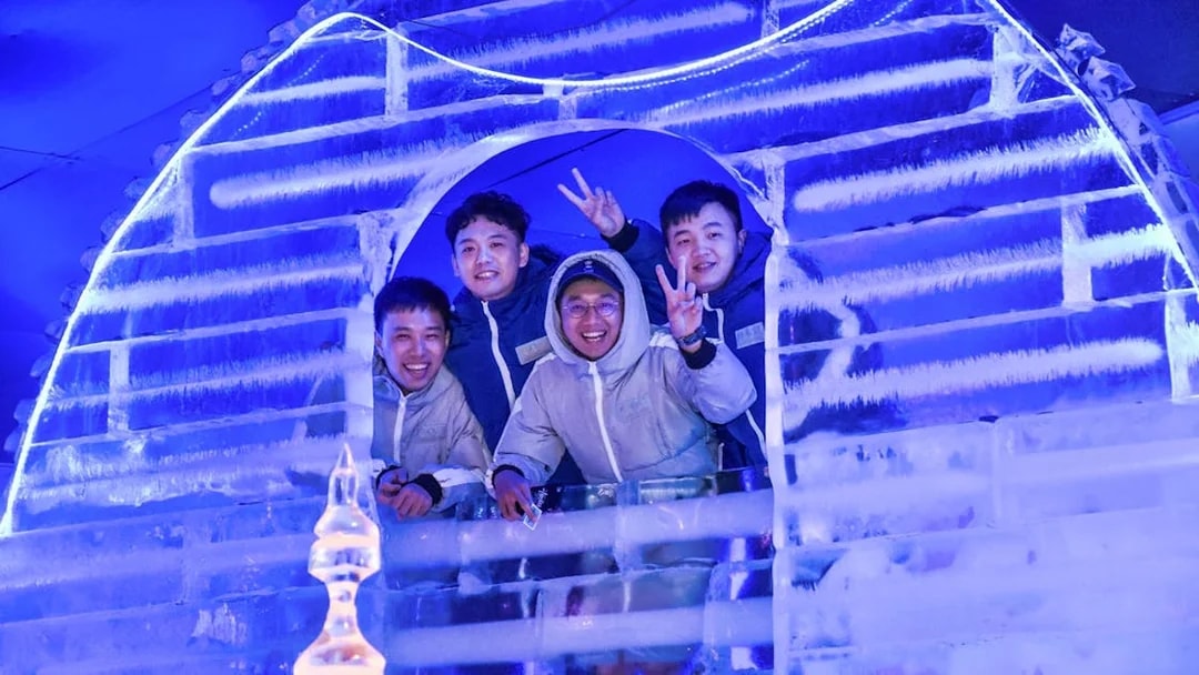 Group enjoying ice sculpture at Frost Magical Ice of Siam, Thailand.