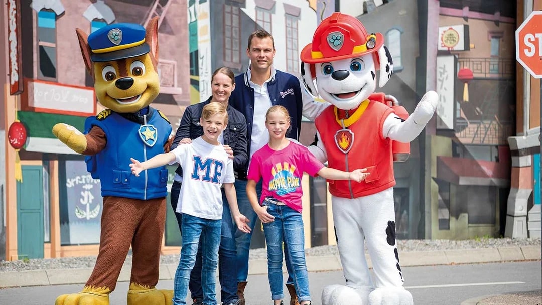 Family posing with PAW Patrol characters at Movie Park.