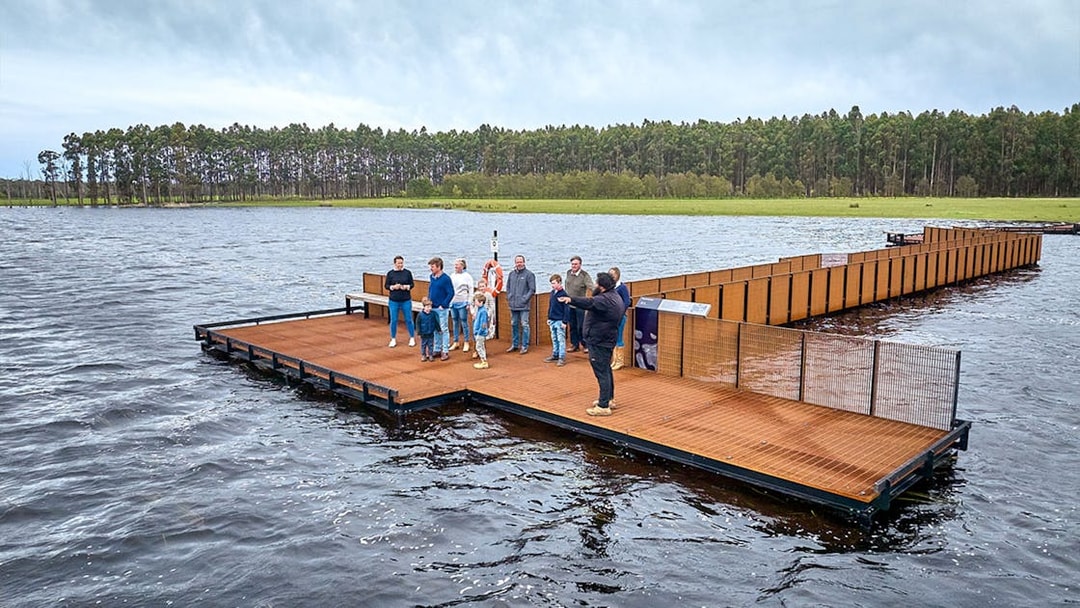 Group of people on a floating platform during Kooyang Yana full day tour, surrounded by water and trees.