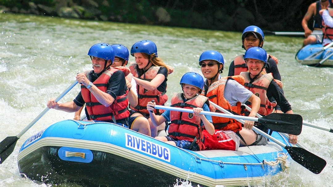Group rafting on Kampar River, Malaysia, during 4-hour white water adventure.