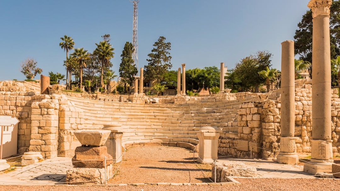 Roman amphitheater ruins in Alexandria, Egypt, with stone columns and seating.