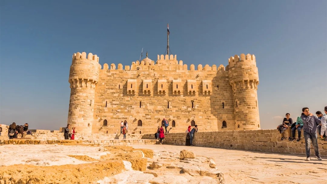 Citadel of Qaitbay in Alexandria with tourists exploring the historic site.