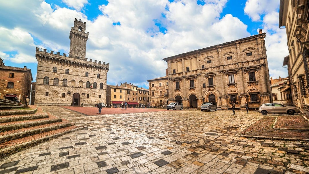 Piazza Grande in Montepulciano, Italy, with historic buildings on a Val D’Orcia tour.