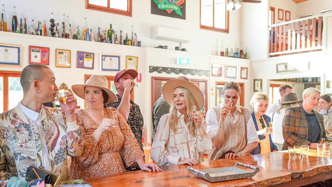 Group enjoying wine tasting at a Gold Coast winery bar.