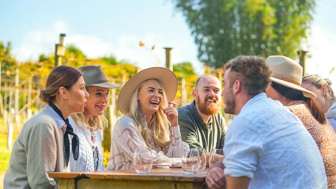 Group enjoying wine tasting at a vineyard on the Gold Coast tour.