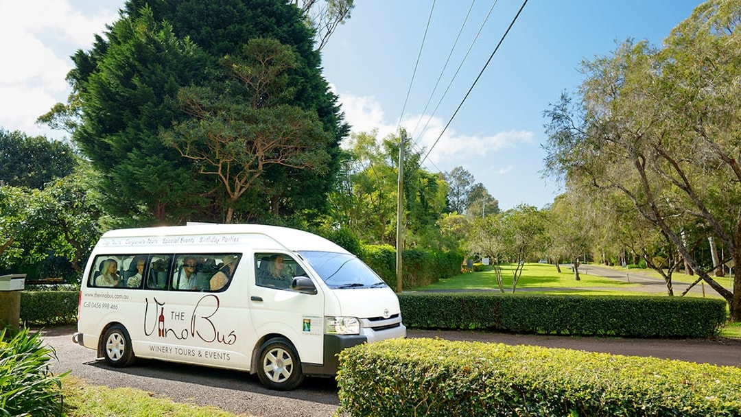 Winery tour bus on a scenic road, Gold Coast pick-up location.