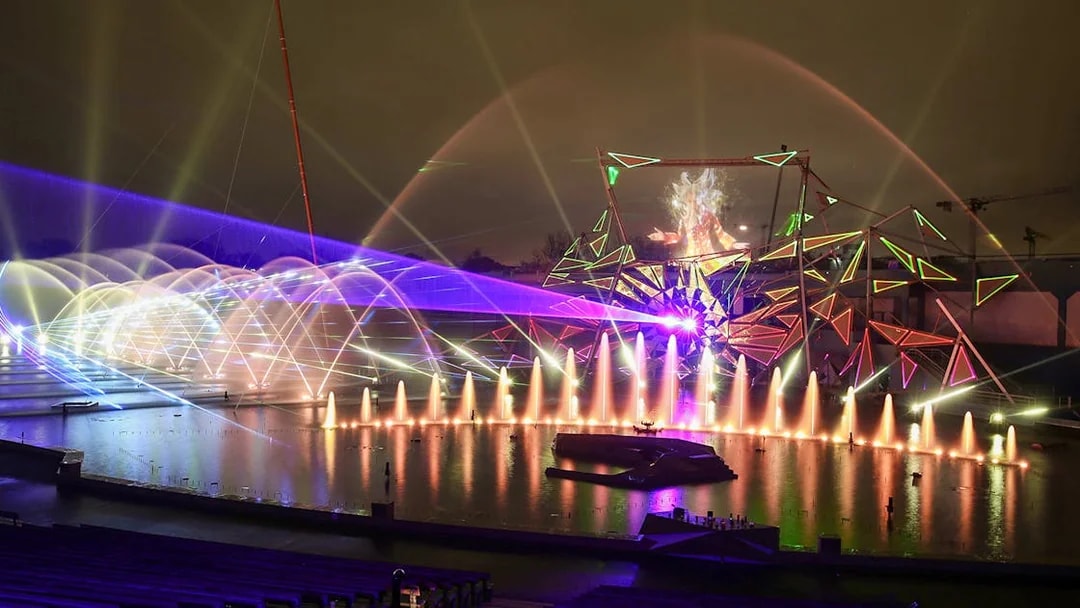 Futuroscope night show with colorful lights and water fountains in Poitiers, France.