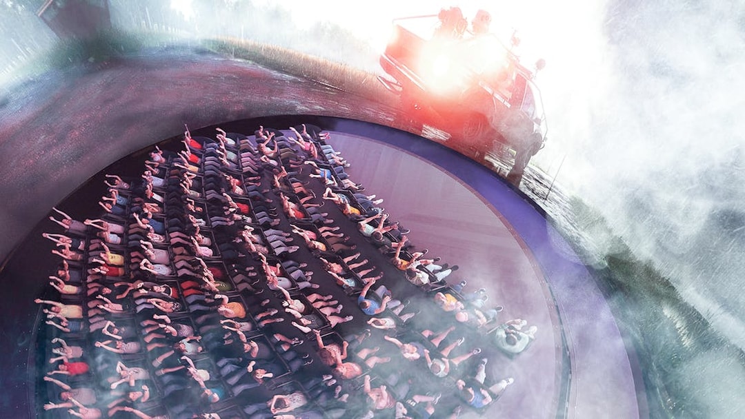 Visitors experiencing Tornado Chasers attraction at Futuroscope with immersive effects.