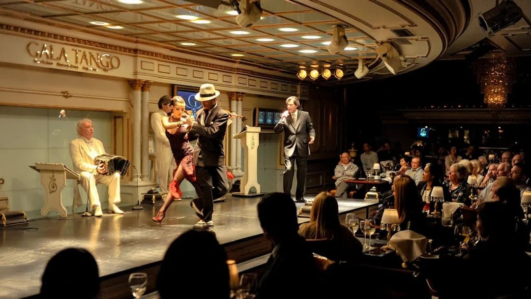 Dancers performing at Gala Tango Show in Buenos Aires with live music.