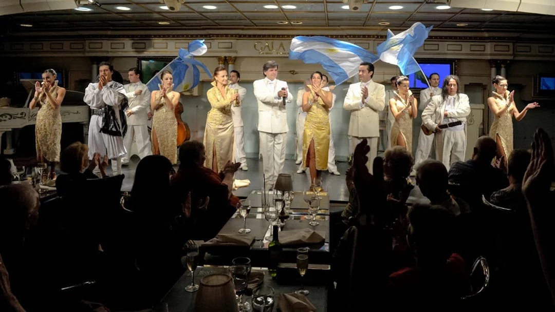 Performers on stage at Gala Tango Show in Buenos Aires, Argentina, with audience clapping.
