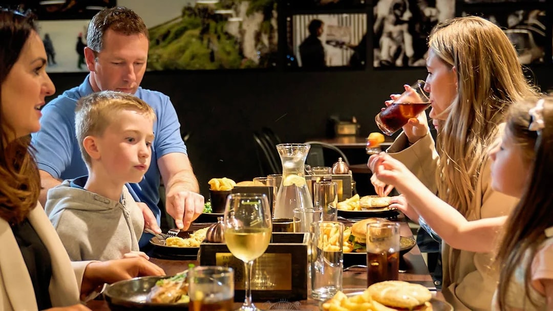 Family dining at a restaurant during Game of Thrones Studio Tour in Belfast.
