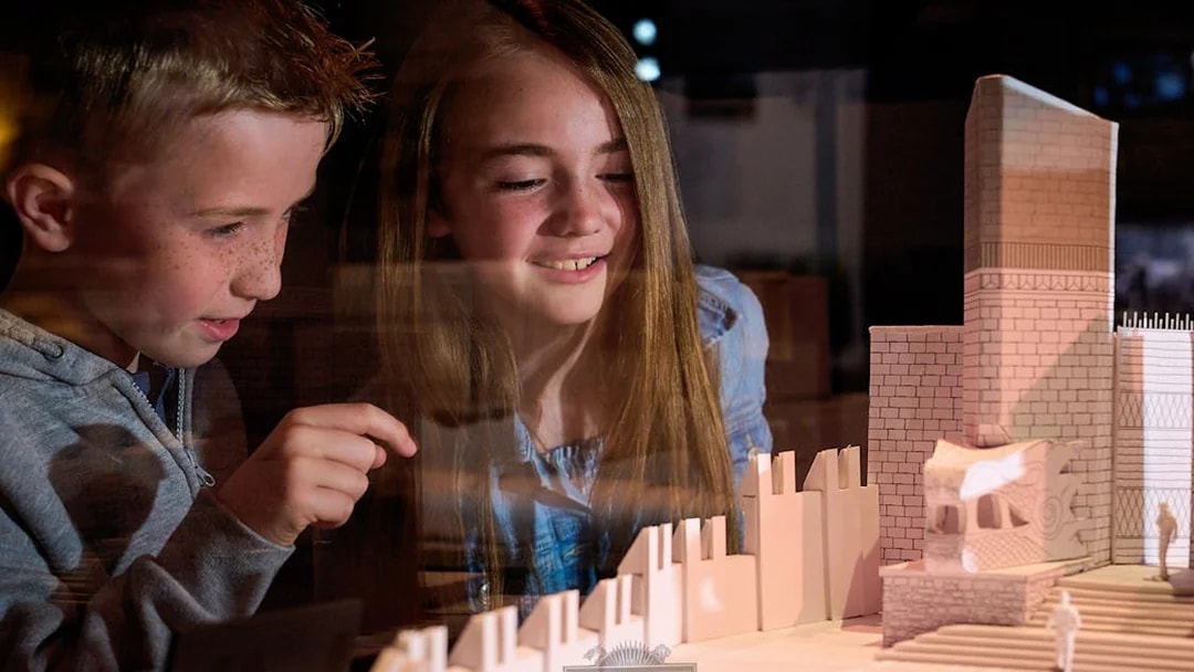 Children observing a Game of Thrones set model at the studio tour.