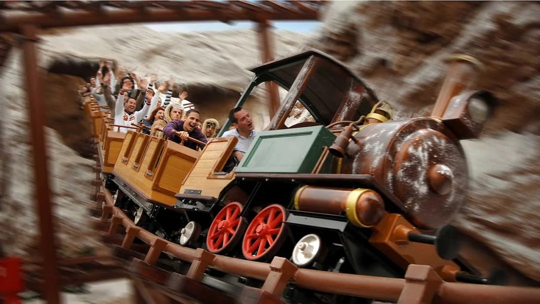 Train model ride with passengers at Gardaland Park.