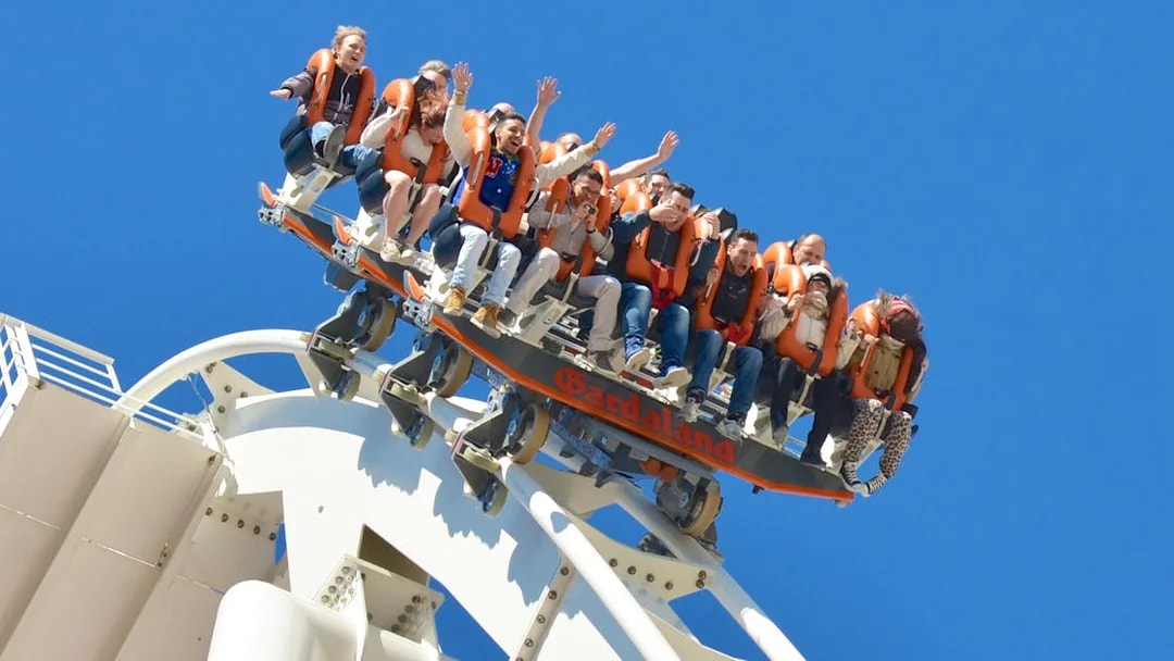 Visitors on a roller coaster at Gardaland Park, Italy, experiencing a thrilling ride.