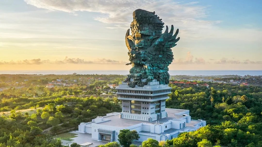 Garuda Wisnu Kencana statue in Bali, Indonesia, surrounded by lush greenery.