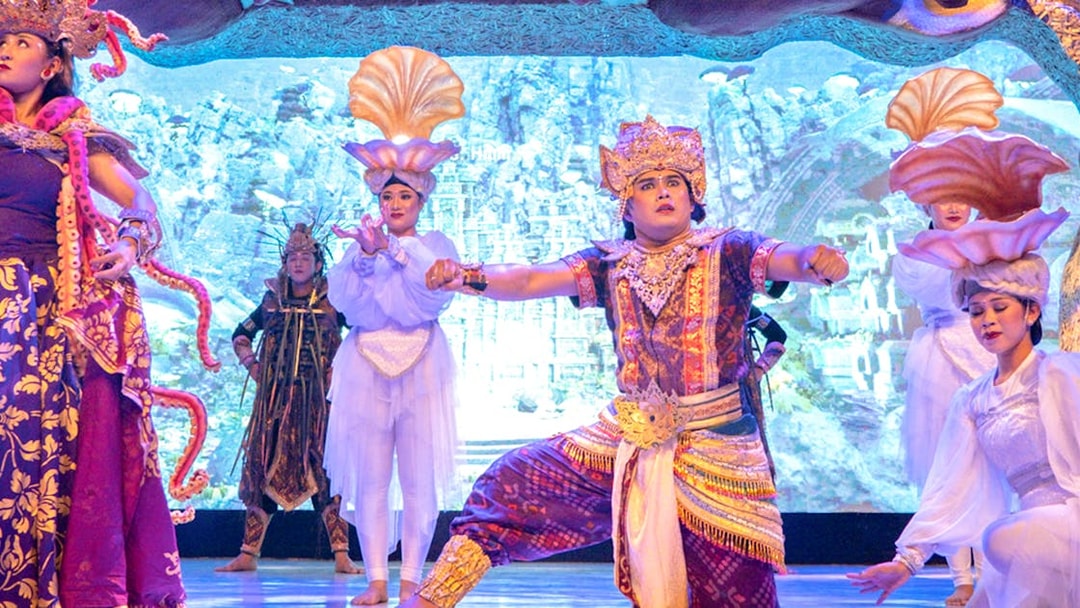 Traditional Balinese dancers performing at Garuda Wisnu Kencana at night.