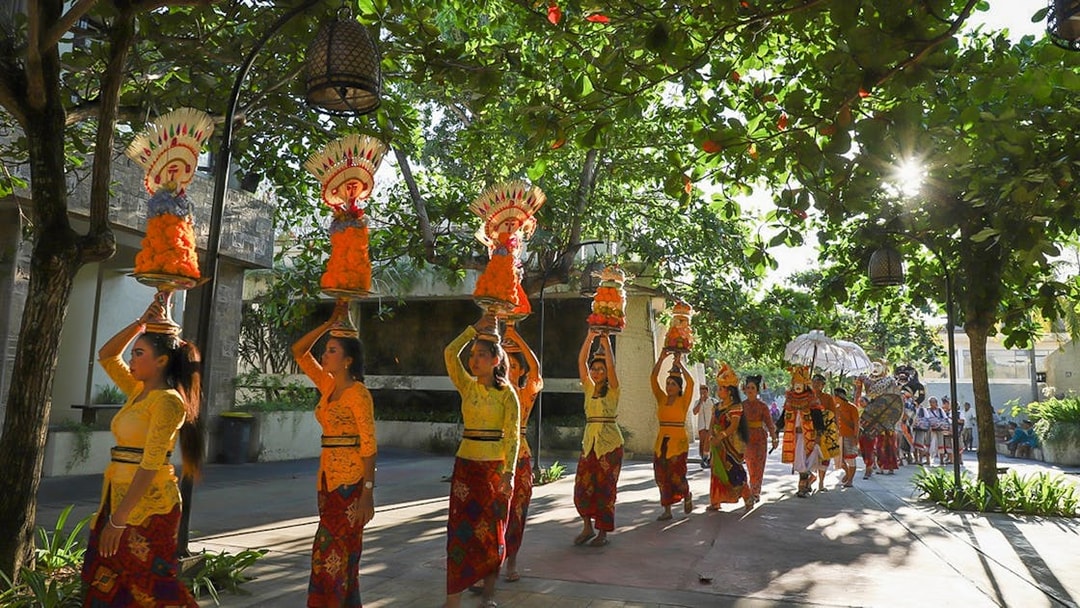Traditional Balinese procession at Garuda Wisnu Kencana Culture Park, Bali.