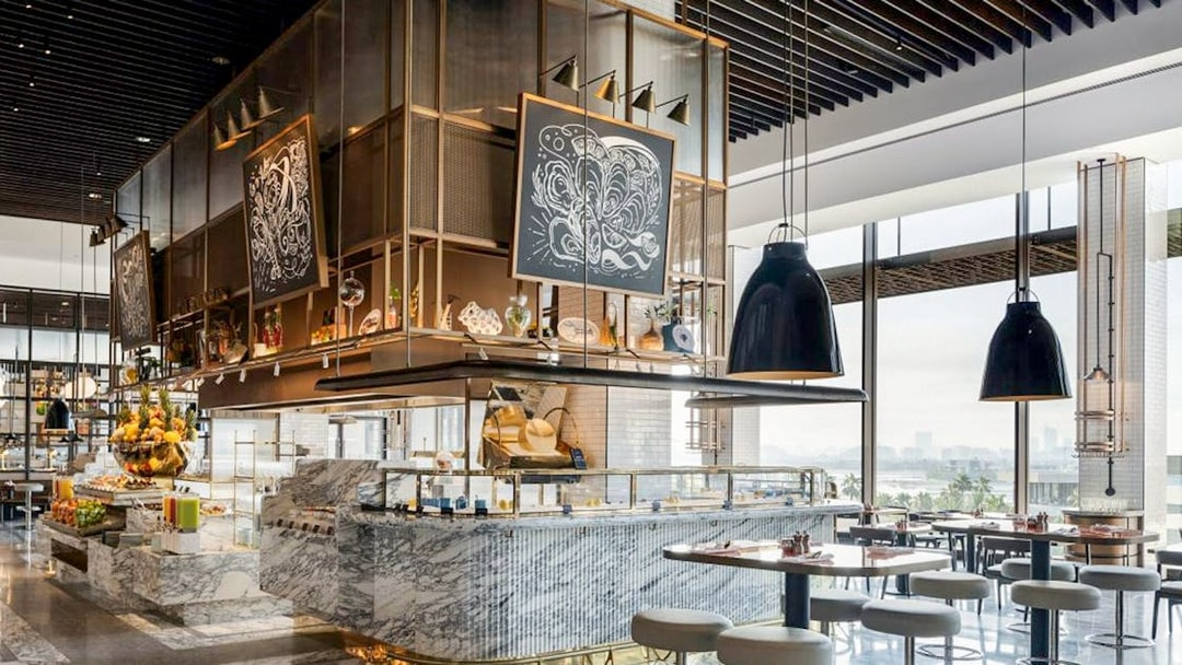 Dining area at Gastronomy, Dubai with marble counters and modern decor.