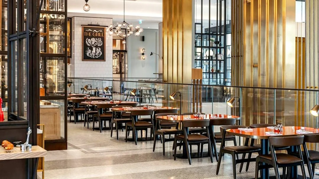 Dining area at Gastronomy, Dubai with modern decor and neatly arranged tables.