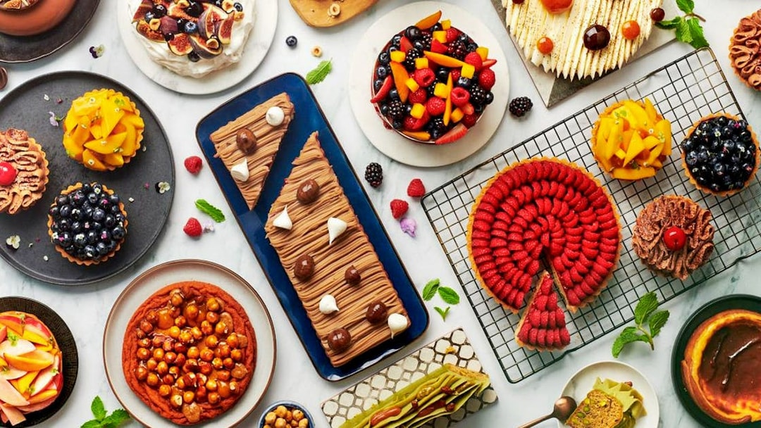 Assorted desserts at Gastronomy Buffet Dinner Experience, Dubai, featuring cakes, tarts, and pastries.