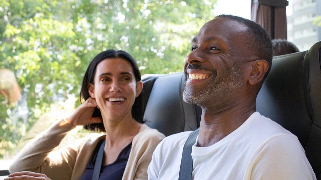 Passengers smiling on a National Express bus ride.