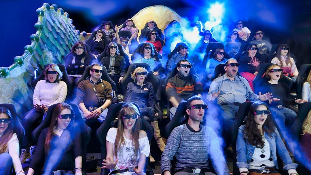 Visitors experiencing Gaudí 4D Experience with 3D glasses and special effects.