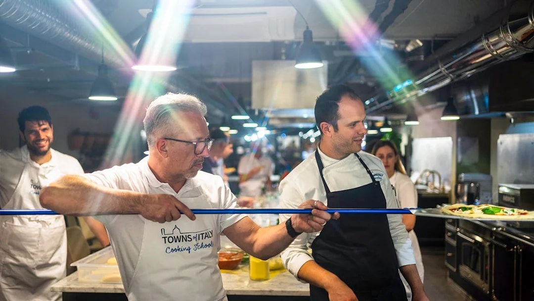 Participants learning to make pizza in a cooking class in Milan.