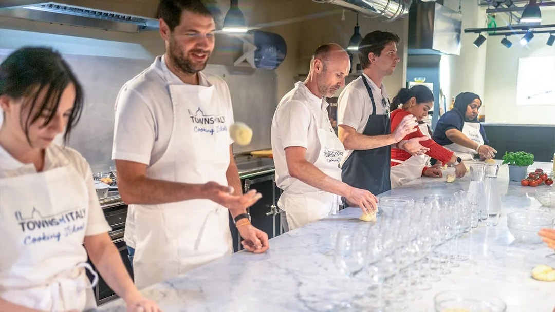Participants making dough at a gelato and pizza class in Milan.