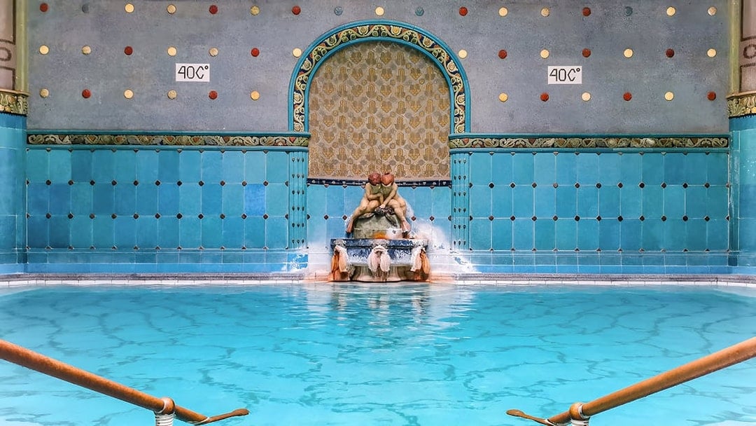 Indoor pool with ornate fountain at Gellert Spa, Budapest.