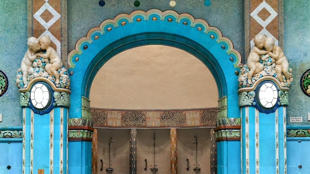 Mosaic blue tiles and ornate archway in Gellert Thermal Bath, Budapest.