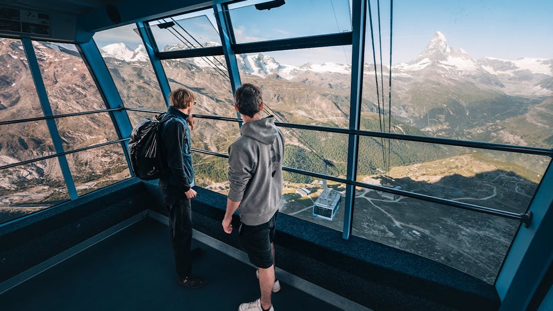 Tourists inside cable car with view of Matterhorn Glacier, Switzerland.